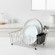 Dish rack with plates and utensils on a kitchen counter